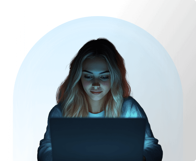 A woman is sitting in front of a laptop. She has Matrix code behind her and is protected by a translucent bubble.